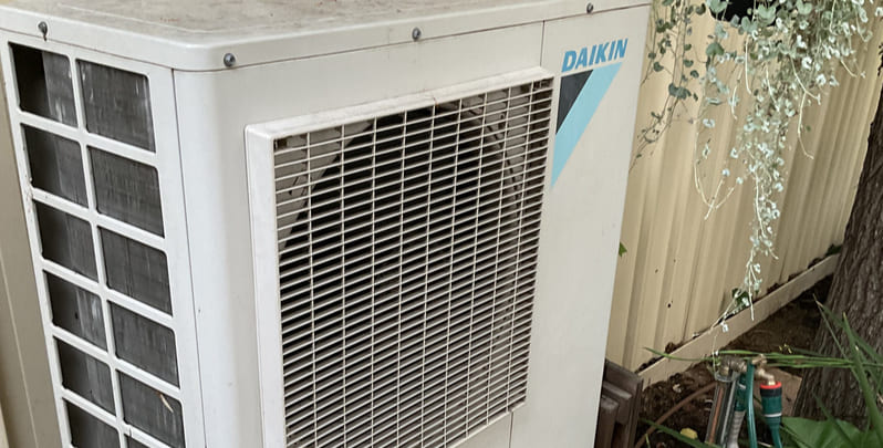Top half of the outdoor unit of a reverse cycle air conditioner.